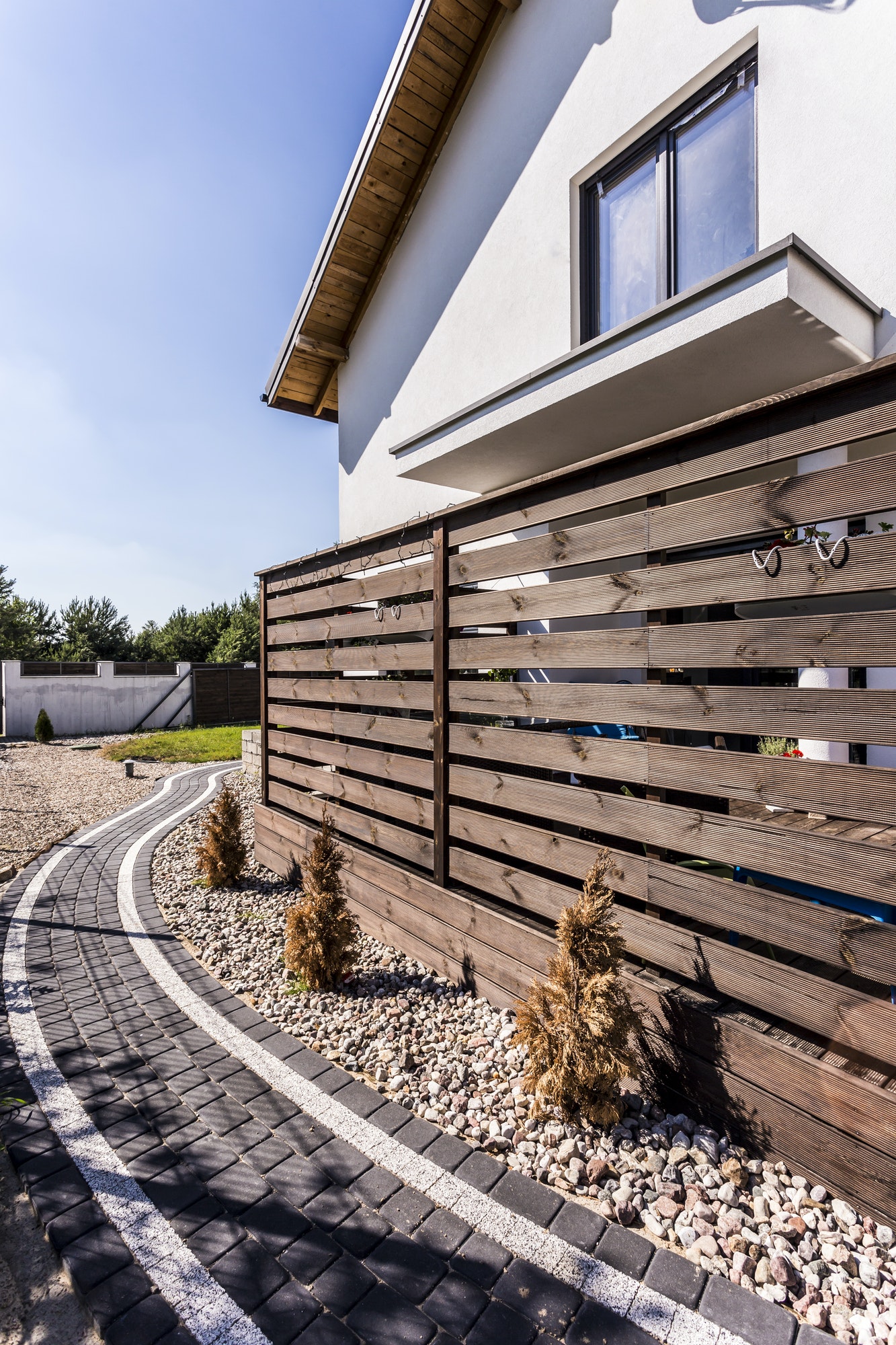 House exterior with wooden arbour