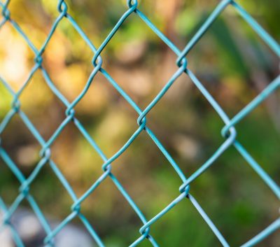 Wire fence with green grass on background